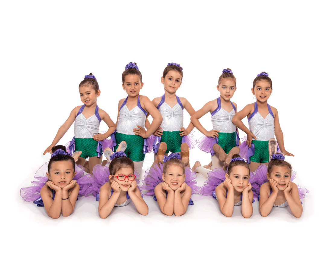 Ten young dancers in green, silver and purple tutu costumes posing in two rows